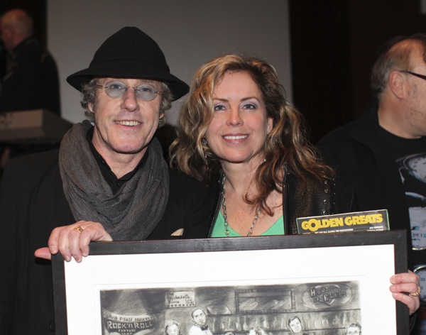 Karen Adams presents artwork to Roger Daltrey.